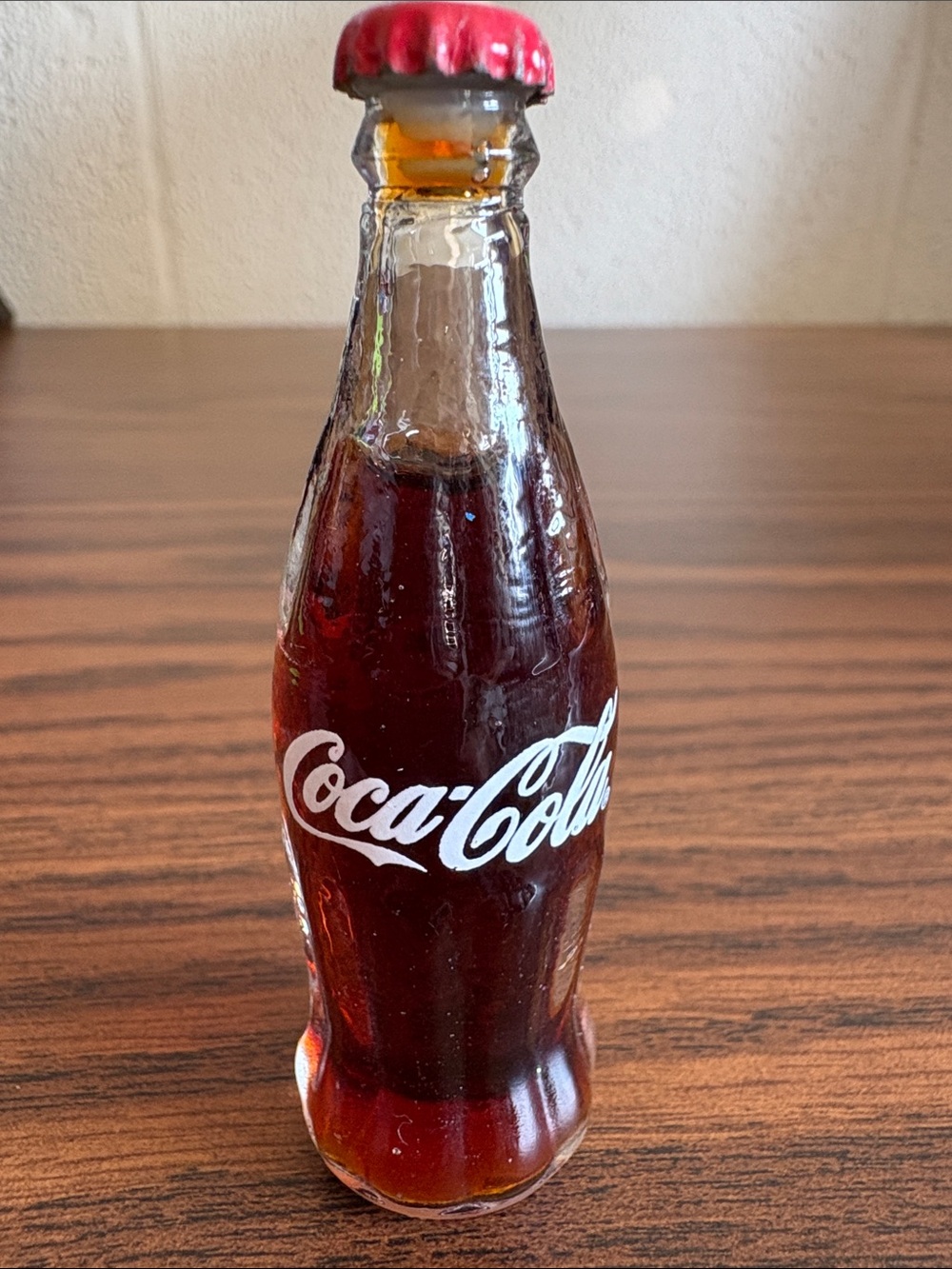 Coca Cola Clear Glass Bottle with White Logo and Red Cap